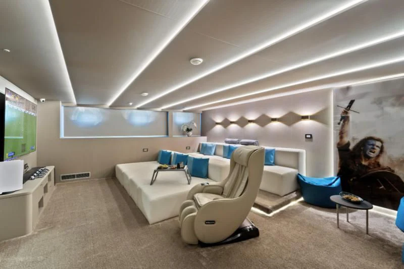 a living room with a couch and a fireplace aboard FREEDOM Yacht for Sale