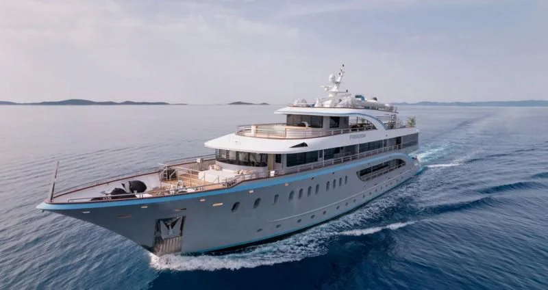 a large white boat in the water aboard FREEDOM Yacht for Sale