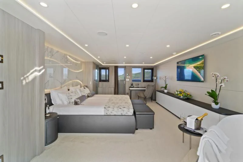a bedroom with a bed and a tv aboard FREEDOM Yacht for Sale