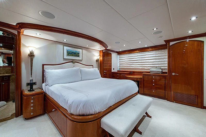 a bedroom with a bed and a chair aboard CIN-TAX Yacht for Sale