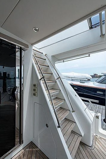 a white boat on a deck aboard CIN-TAX Yacht for Sale