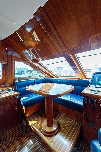 a room with a table and a couch aboard CIN-TAX Yacht for Sale
