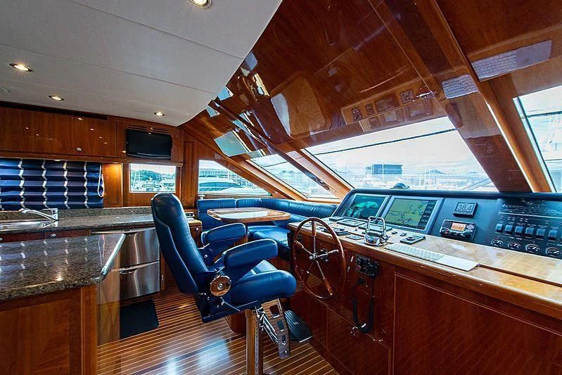 a room with a bar and a table and chairs aboard CIN-TAX Yacht for Sale