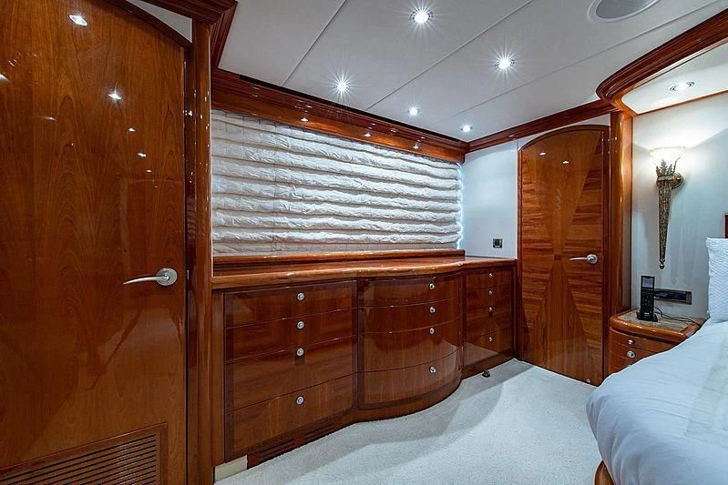 a bedroom with a bed and a dresser aboard CIN-TAX Yacht for Sale