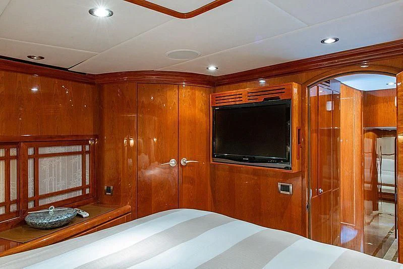 a bedroom with a wood wall aboard CIN-TAX Yacht for Sale