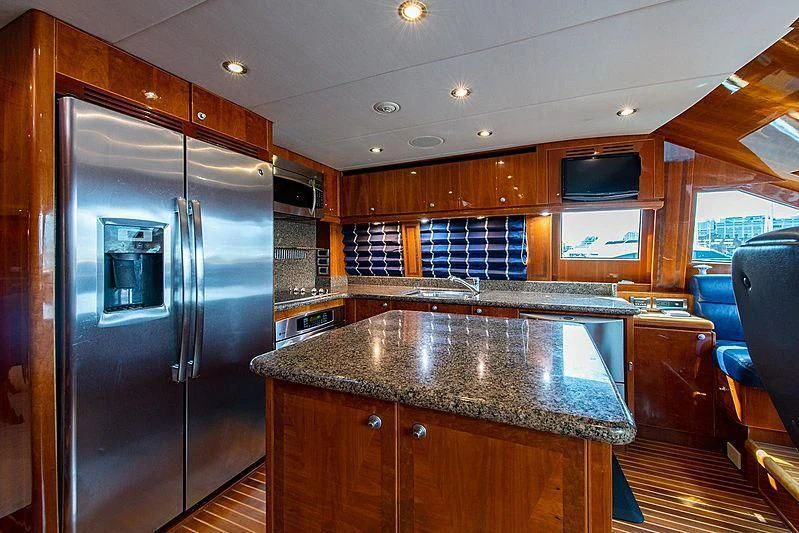 a kitchen with a stainless steel refrigerator aboard CIN-TAX Yacht for Sale