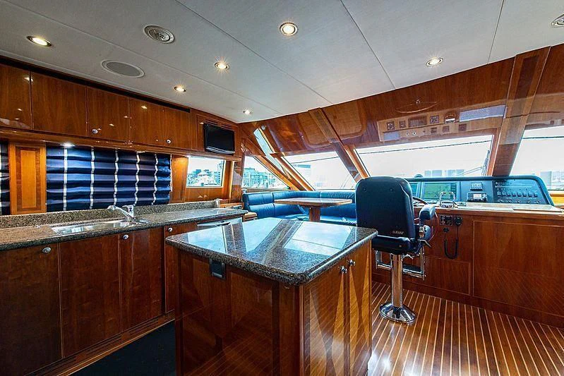 a large kitchen with wooden cabinets aboard CIN-TAX Yacht for Sale