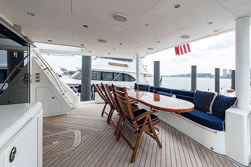 a boat with a table and chairs aboard CIN-TAX Yacht for Sale