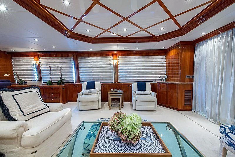 a living room with a large glass table and chairs aboard CIN-TAX Yacht for Sale