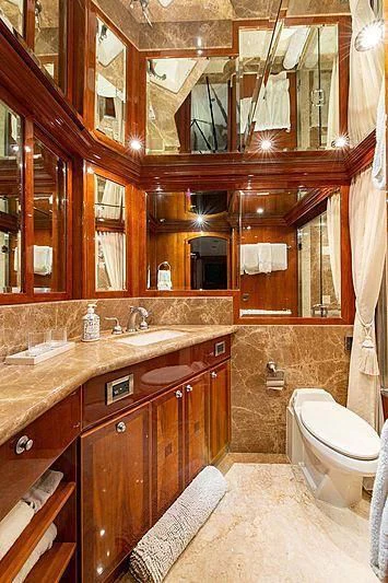 a bathroom with a sink toilet and a mirror aboard CIN-TAX Yacht for Sale