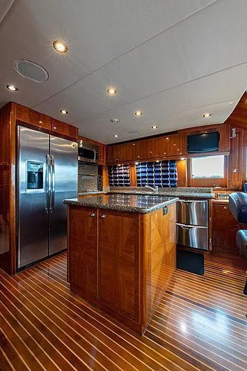 a kitchen with a stainless steel refrigerator aboard CIN-TAX Yacht for Sale