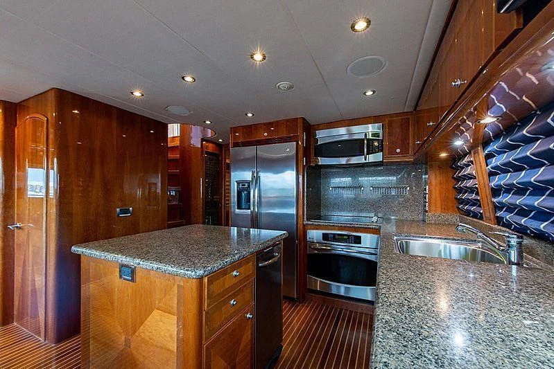 a kitchen with a stainless steel refrigerator aboard CIN-TAX Yacht for Sale
