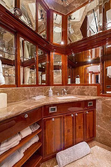 a bathroom with wooden cabinets aboard CIN-TAX Yacht for Sale