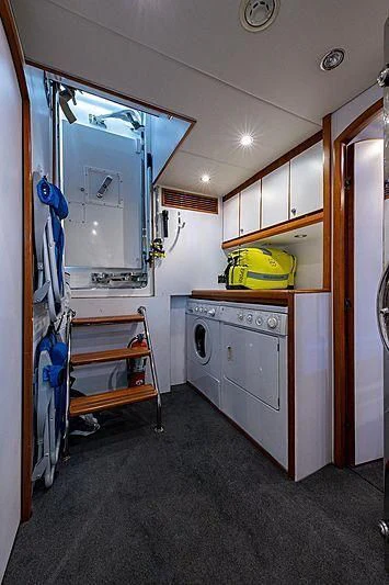 a room with a laundry machine and a closet aboard CIN-TAX Yacht for Sale