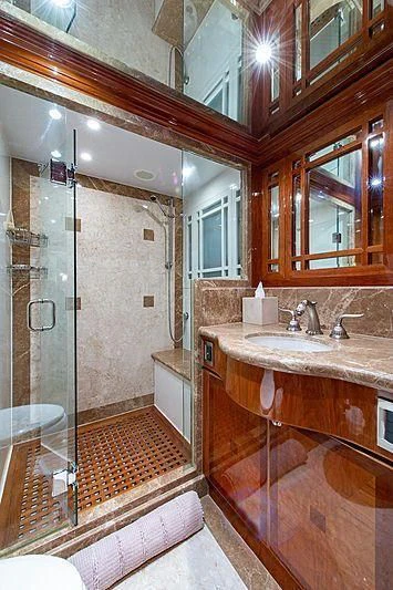 a bathroom with a glass shower aboard CIN-TAX Yacht for Sale