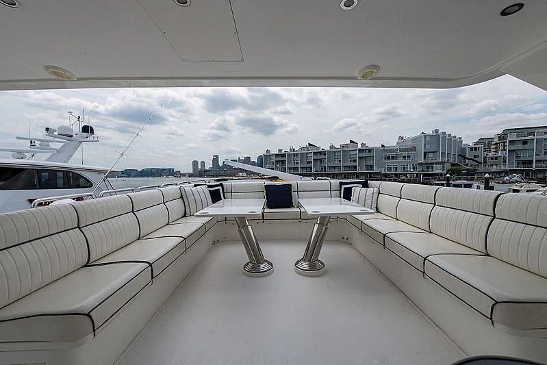 a room with white couches and a city in the background aboard CIN-TAX Yacht for Sale