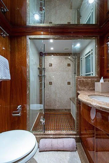 a bathroom with a glass shower aboard CIN-TAX Yacht for Sale