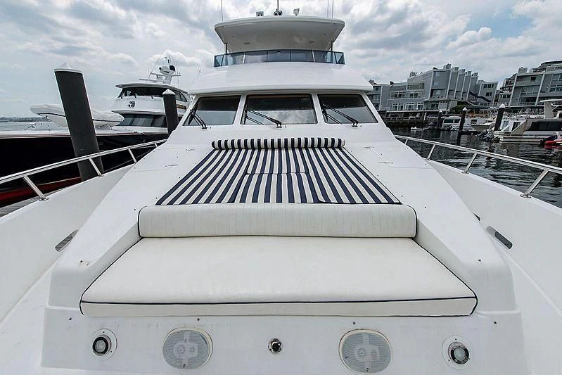 a white yacht in a harbor aboard CIN-TAX Yacht for Sale