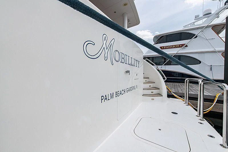 a white boat with a black text on it aboard CIN-TAX Yacht for Sale