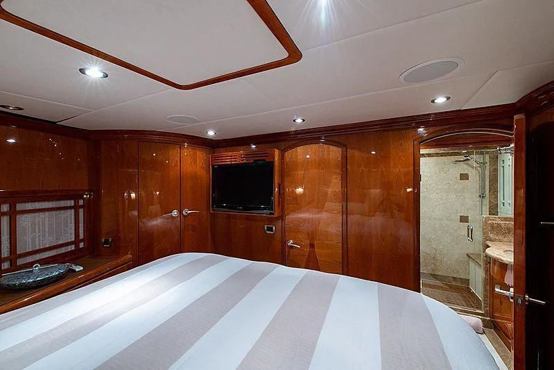 a large bathroom with wooden cabinets aboard CIN-TAX Yacht for Sale