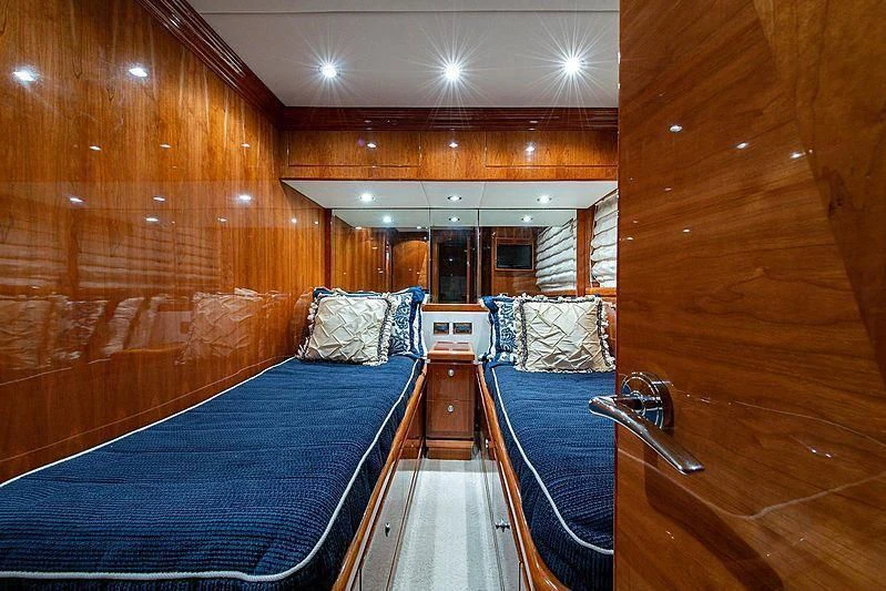 a room with a bed and a wood wall aboard CIN-TAX Yacht for Sale