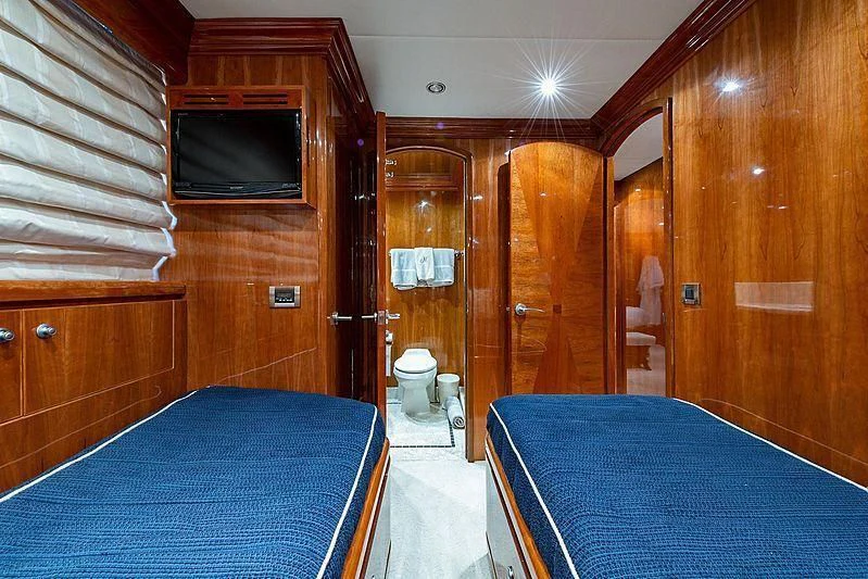 a bedroom with a bed and a television aboard CIN-TAX Yacht for Sale