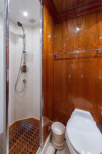 a bathroom with a toilet and shower aboard CIN-TAX Yacht for Sale