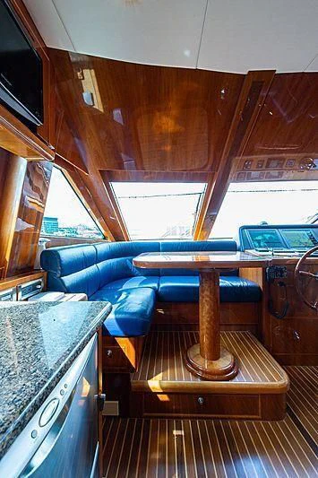 a boat with a table and chairs aboard CIN-TAX Yacht for Sale