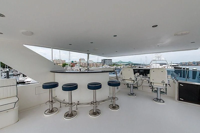 a room with stools and tables aboard CIN-TAX Yacht for Sale