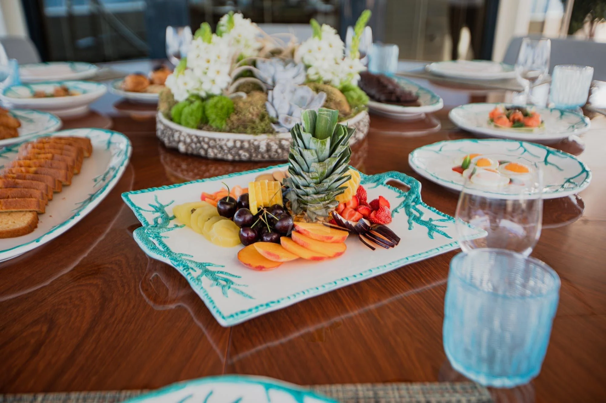 a table with plates of food and glasses of water aboard MARLA Yacht for Sale