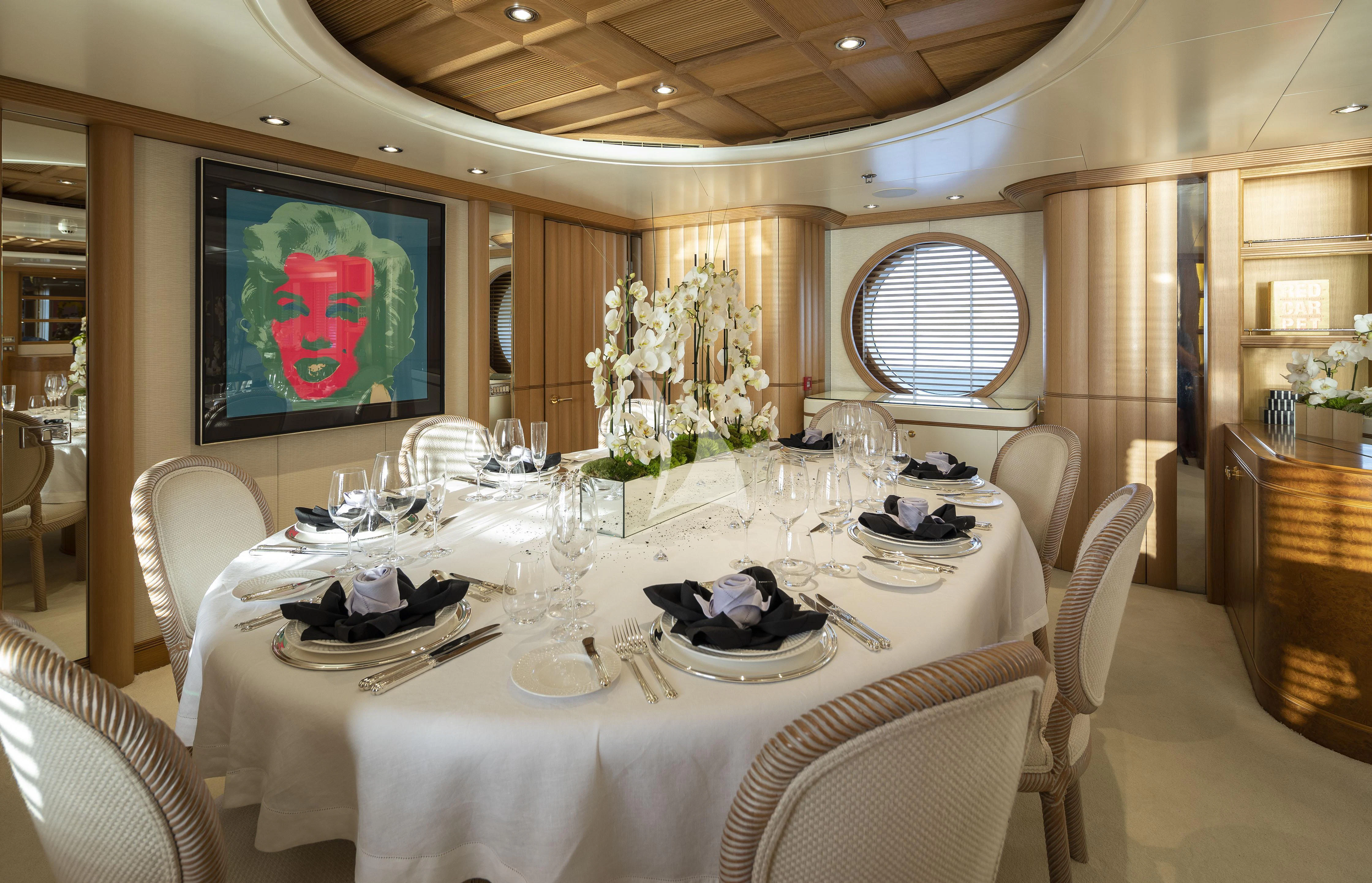 a dining room with a table set aboard MARLA Yacht for Sale