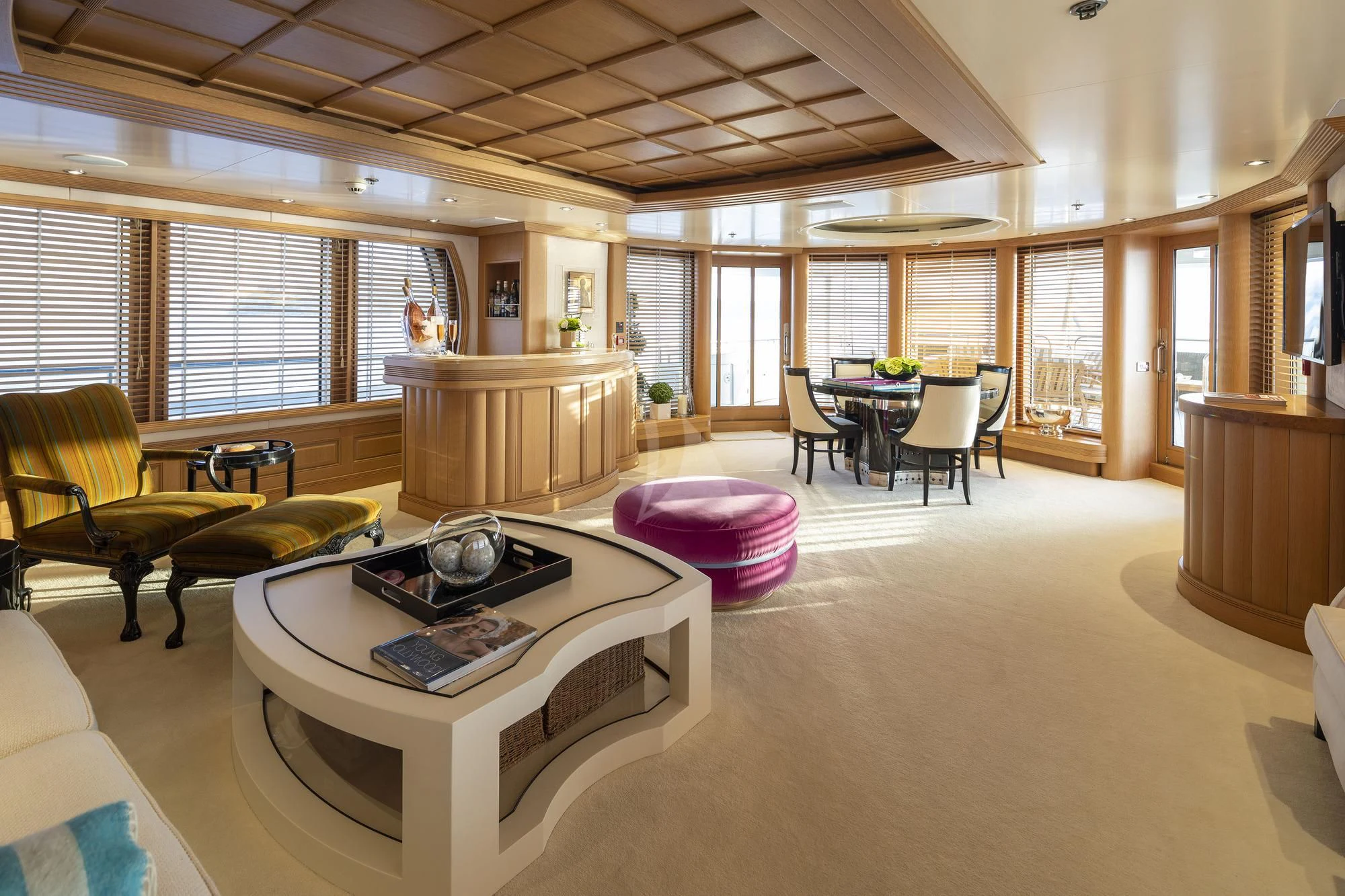 a large living room with a table and chairs aboard MARLA Yacht for Sale