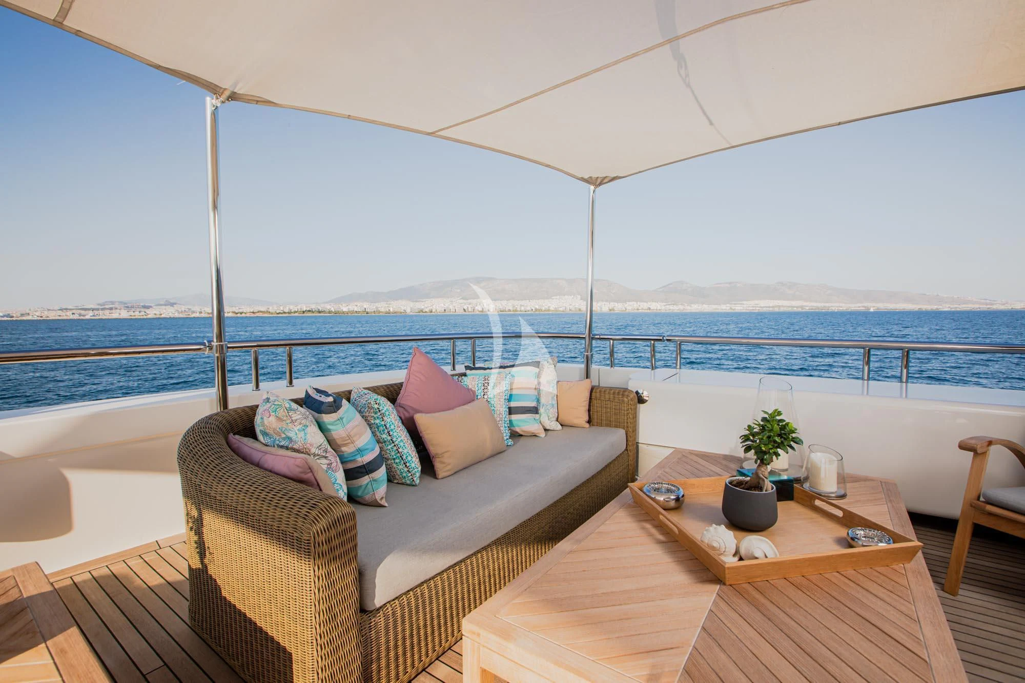 a bed and a table on a balcony aboard MARLA Yacht for Sale