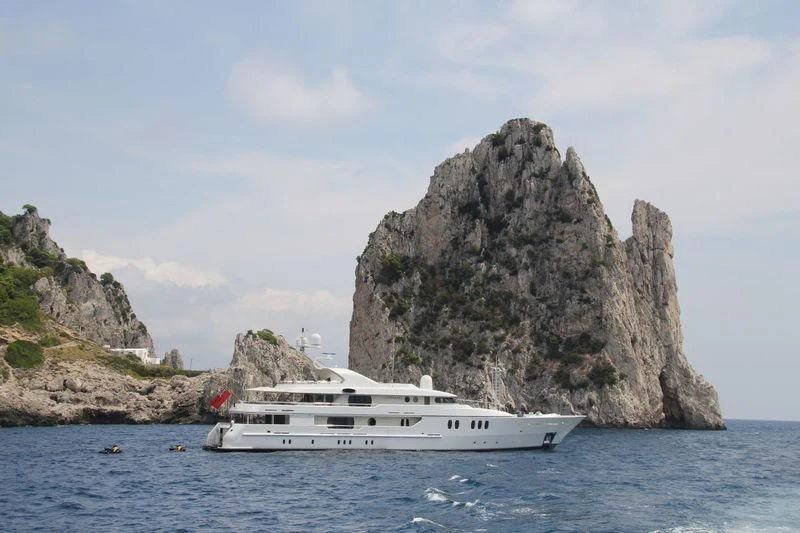 a boat in the water by a rock cliff aboard MARLA Yacht for Sale