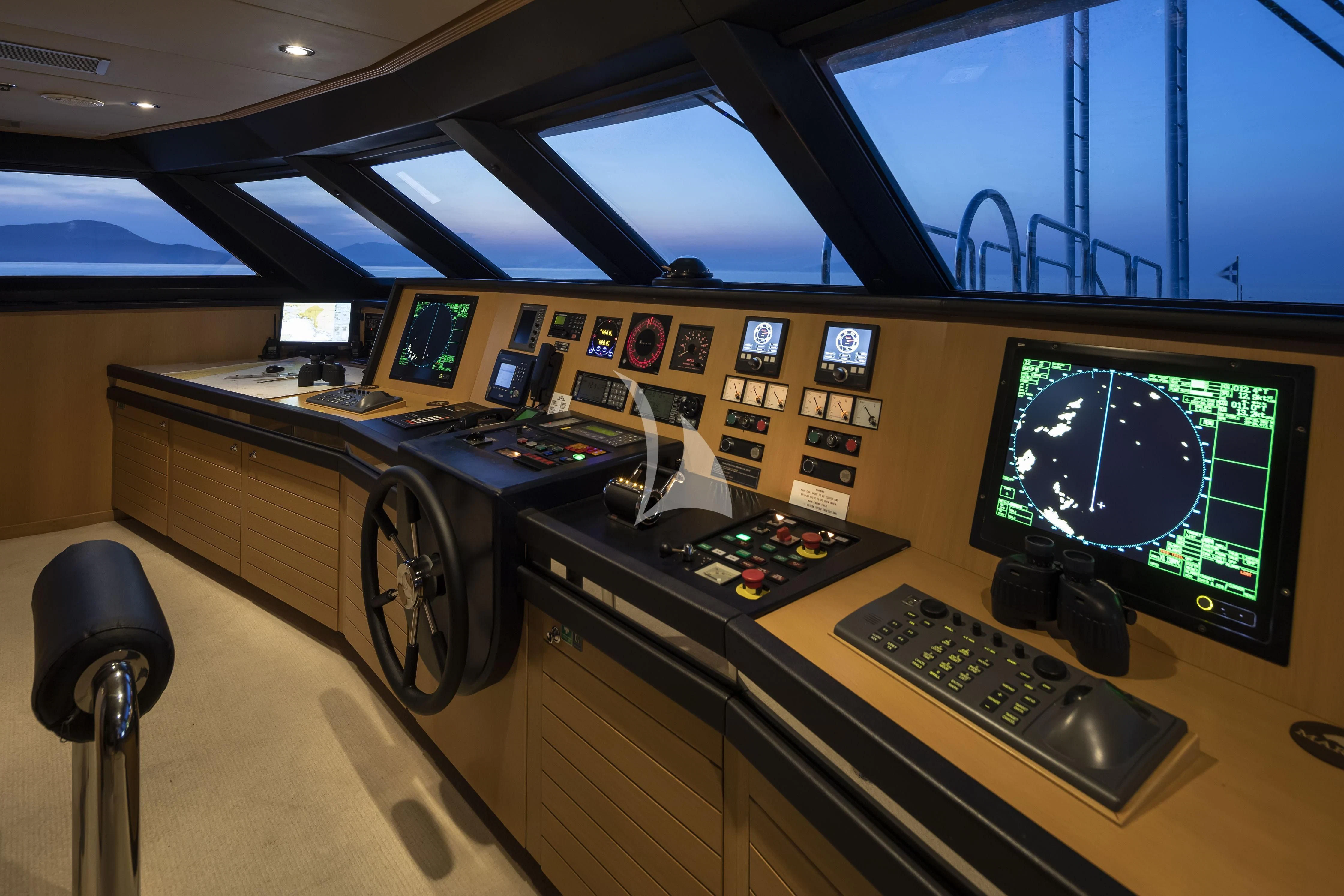 a control room with a couple of monitors and a large clock aboard MARLA Yacht for Sale