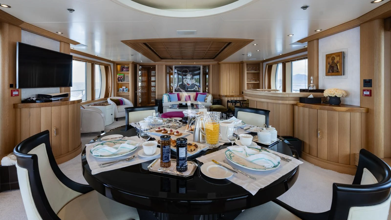 a dining table with plates and cups aboard MARLA Yacht for Sale