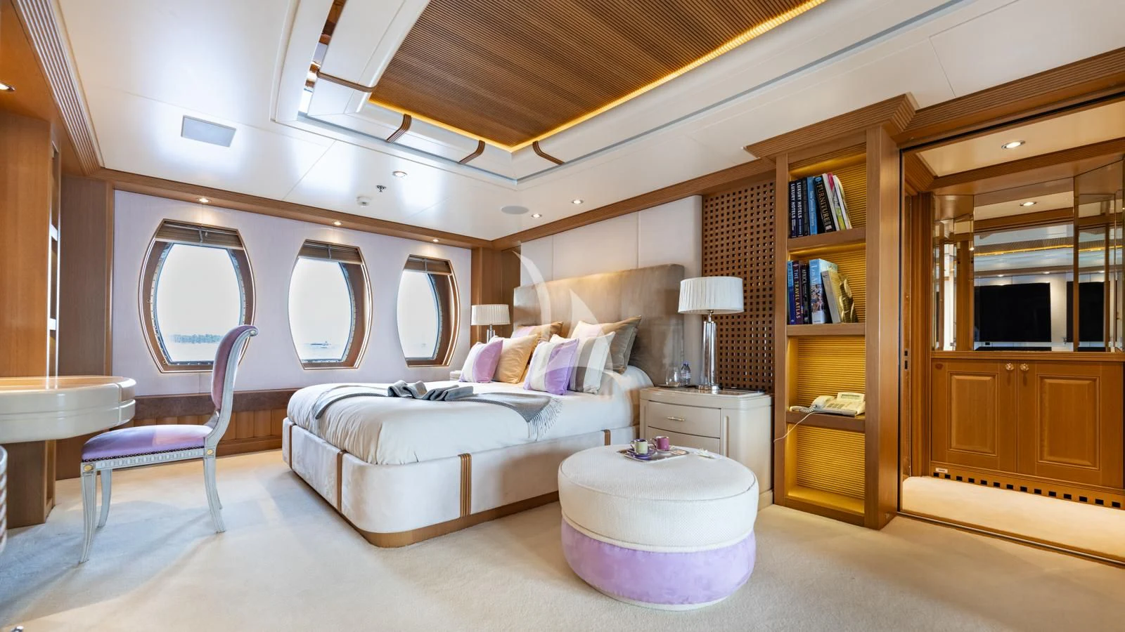 a bedroom with a bed and a chair aboard MARLA Yacht for Sale