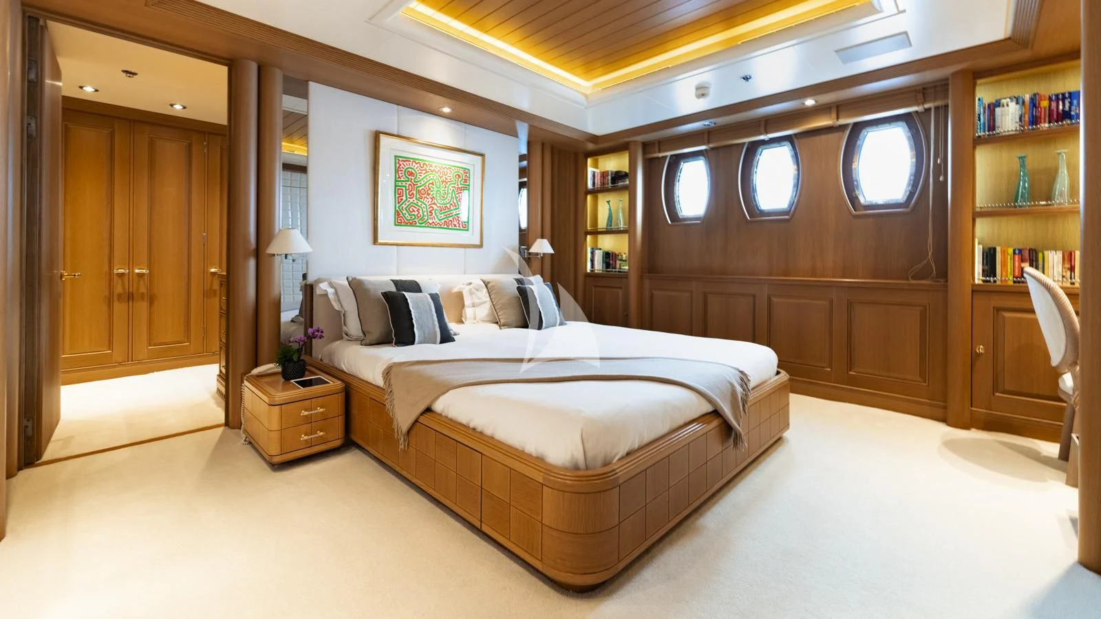 a bedroom with a bed and a bookcase aboard MARLA Yacht for Sale