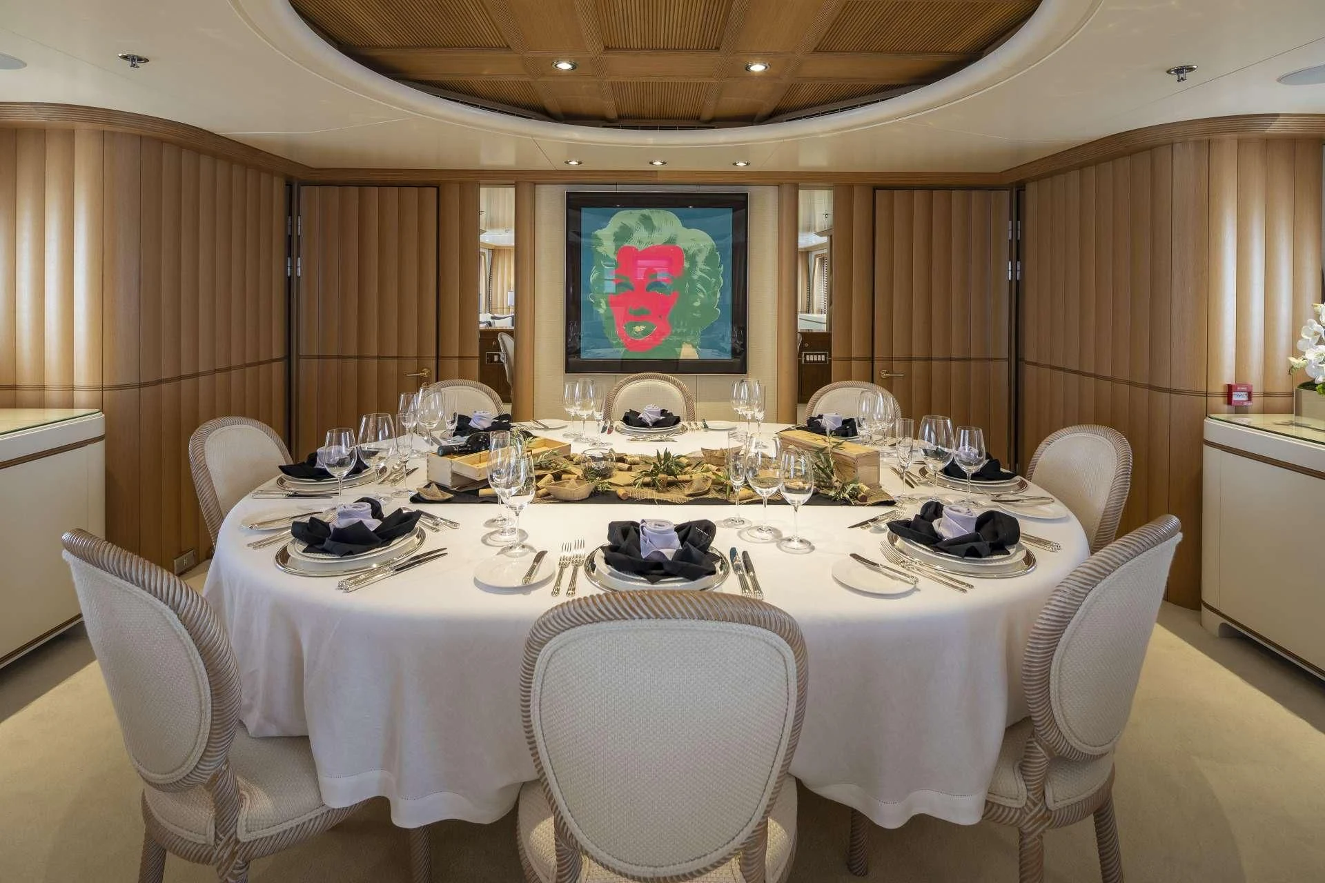 a dining room with a table set for a dinner aboard MARLA Yacht for Sale