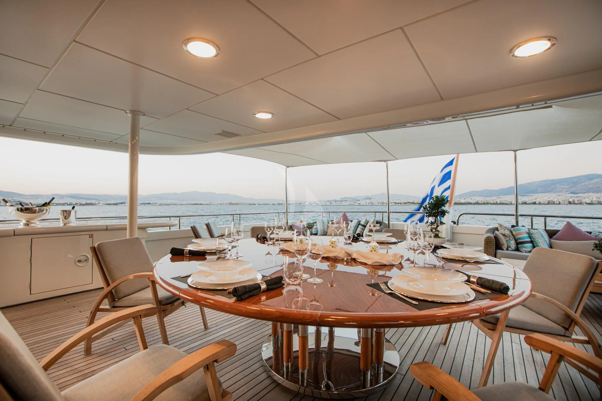a dining table with chairs and a view of the water aboard MARLA Yacht for Sale