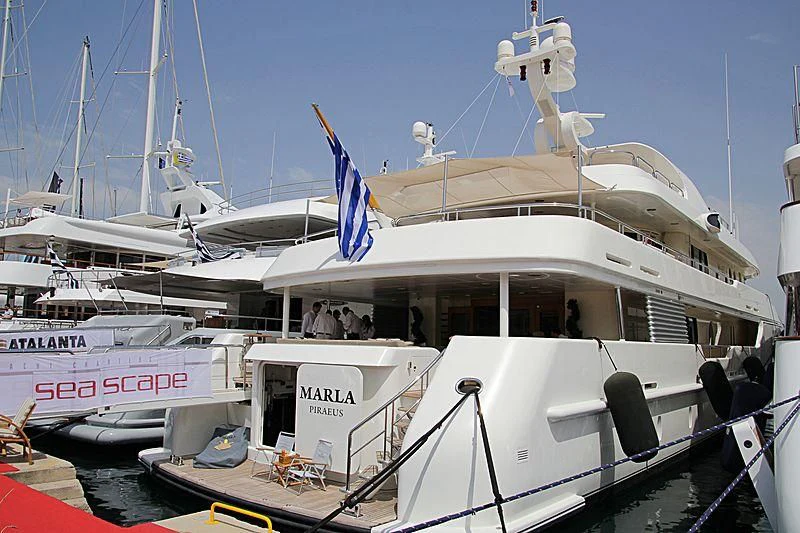 a boat with a flag on the front aboard MARLA Yacht for Sale