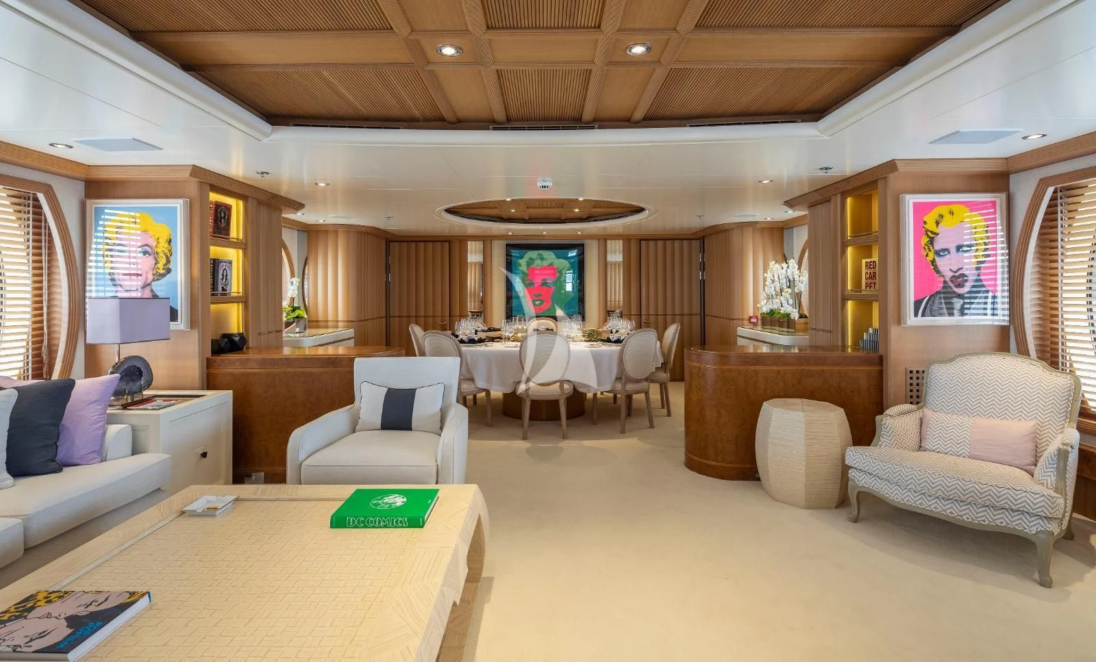 a living room with a large wood table and chairs aboard MARLA Yacht for Sale