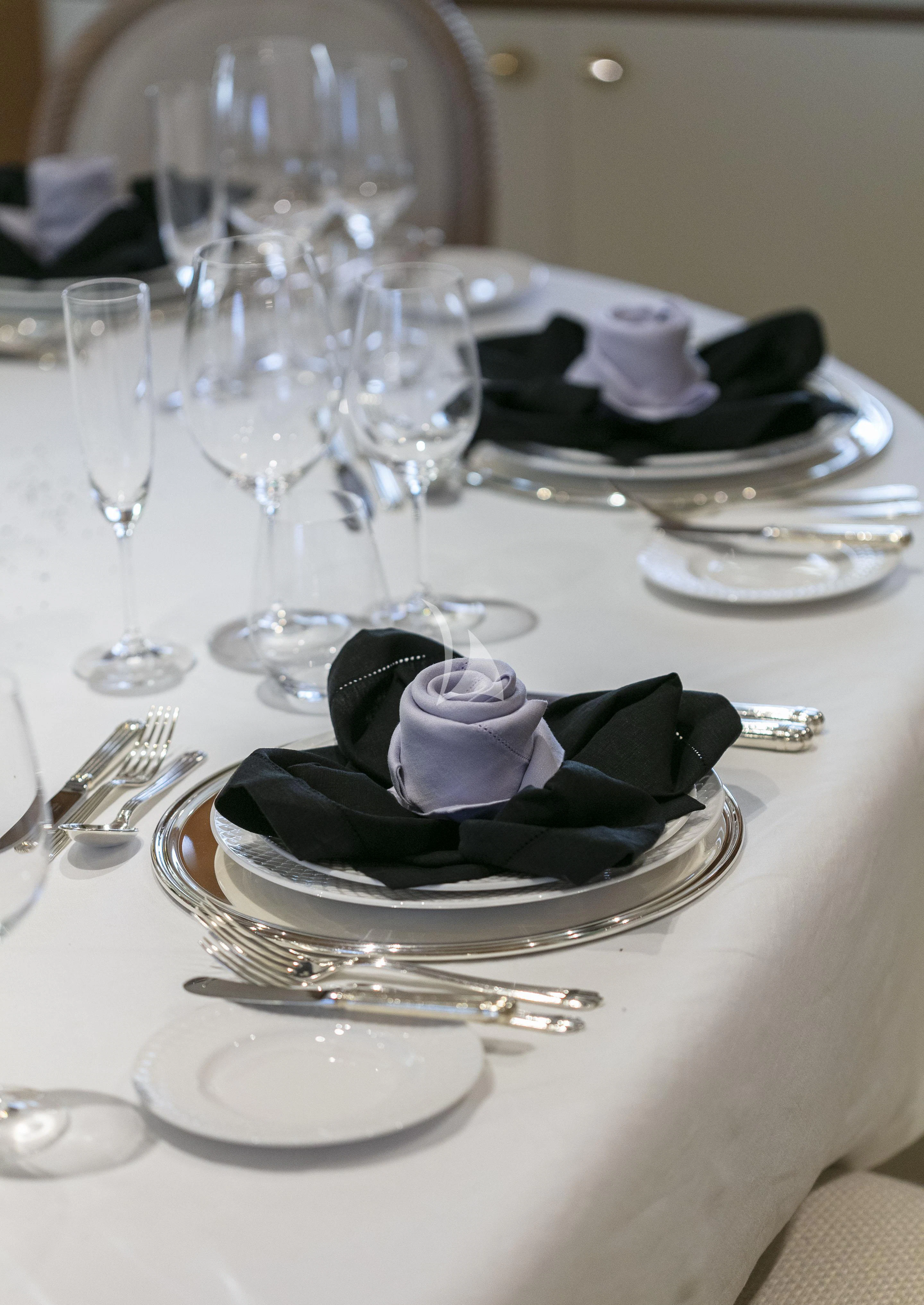 a table with plates and glasses aboard MARLA Yacht for Sale