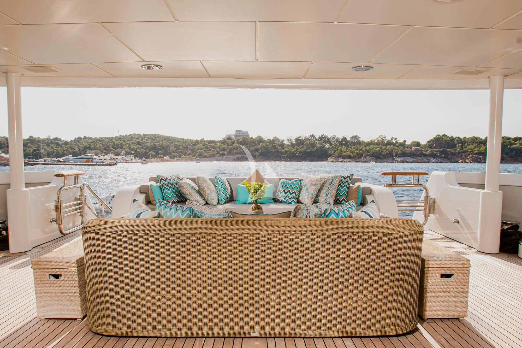a room with a couch and a table with chairs and a view of a city aboard MARLA Yacht for Sale