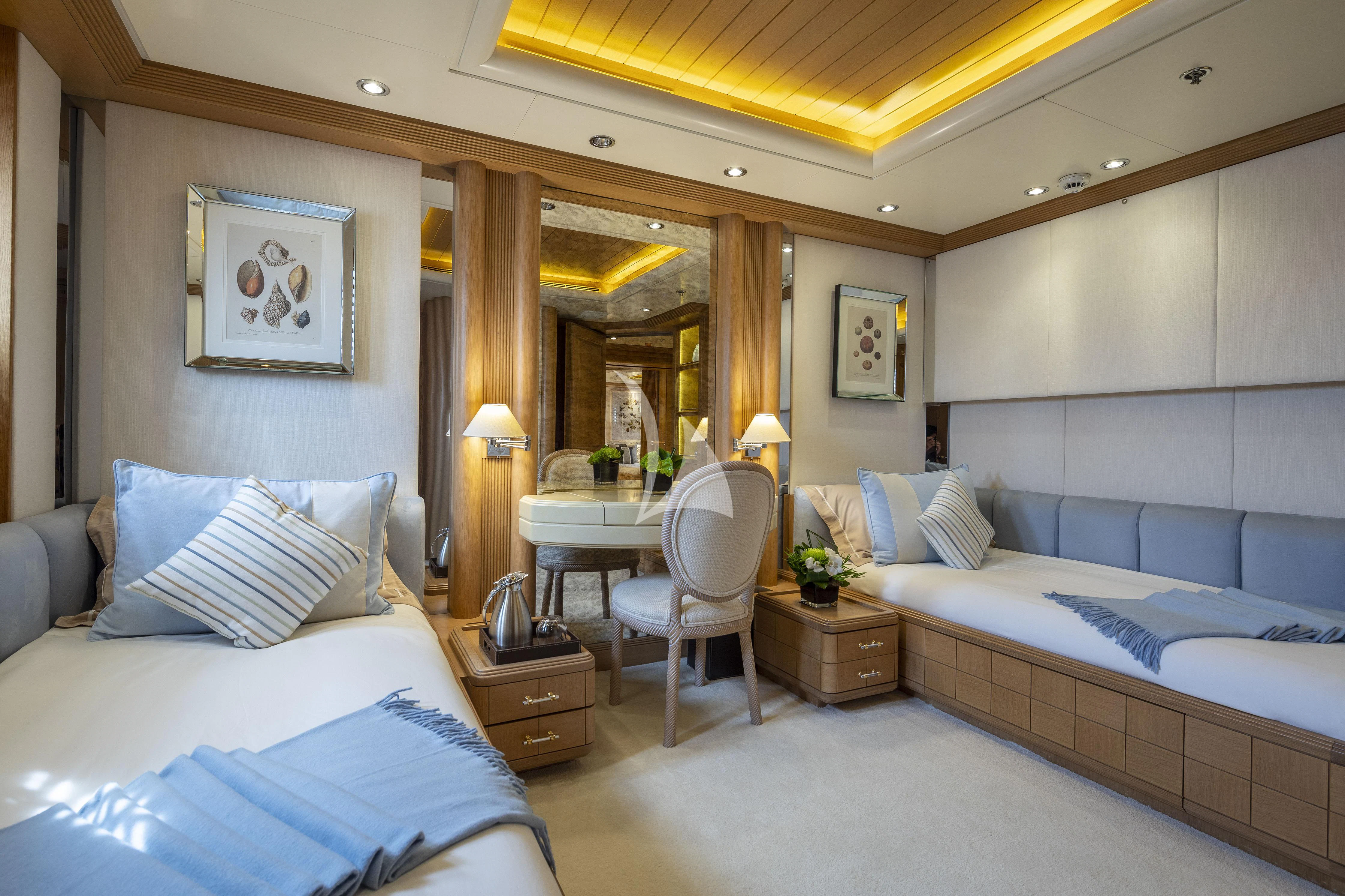 a bedroom with a bed and a desk aboard MARLA Yacht for Sale