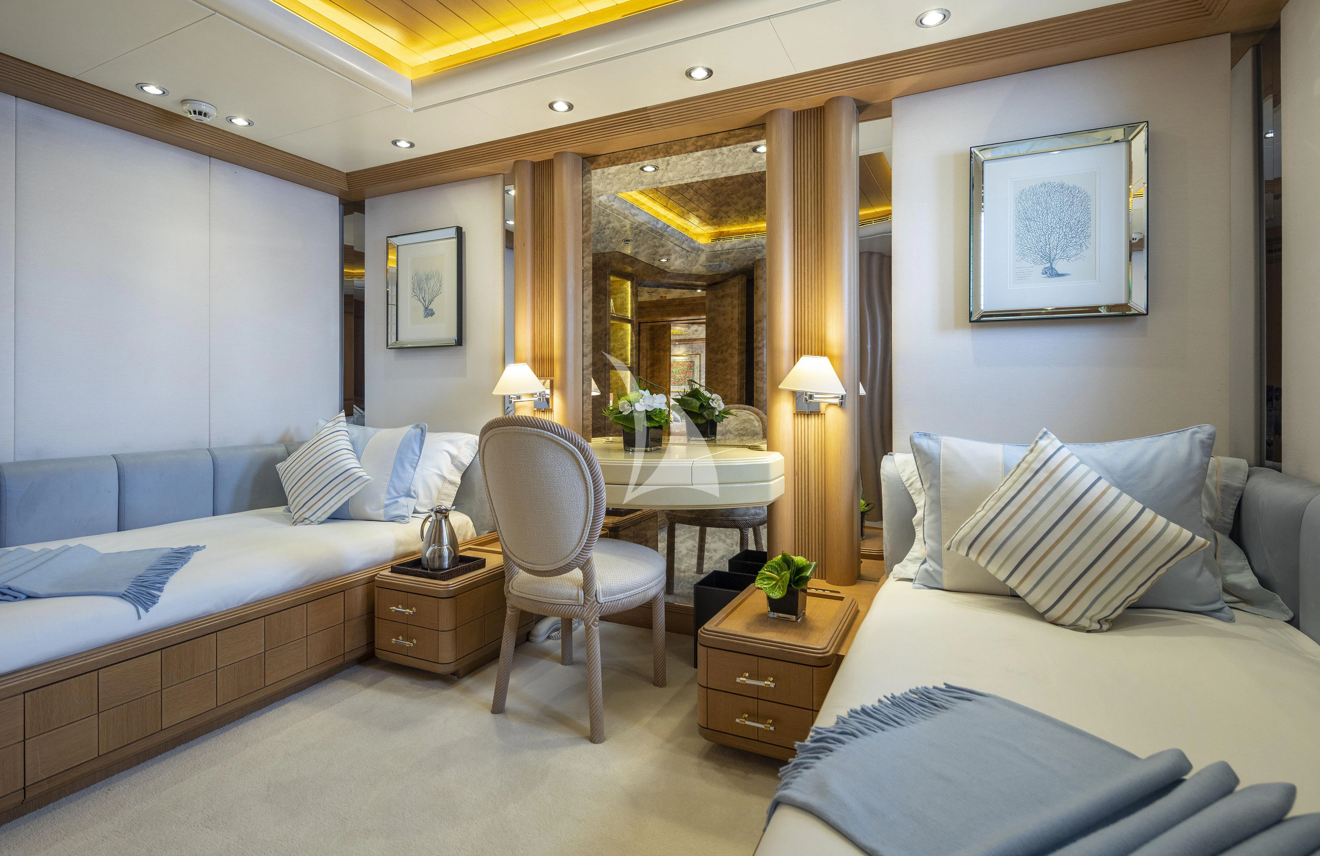 a room with a bed and a chair aboard MARLA Yacht for Sale