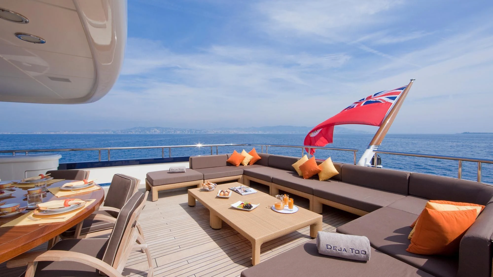 a room with a table and chairs and an umbrella on the roof aboard DEJA TOO Yacht for Sale