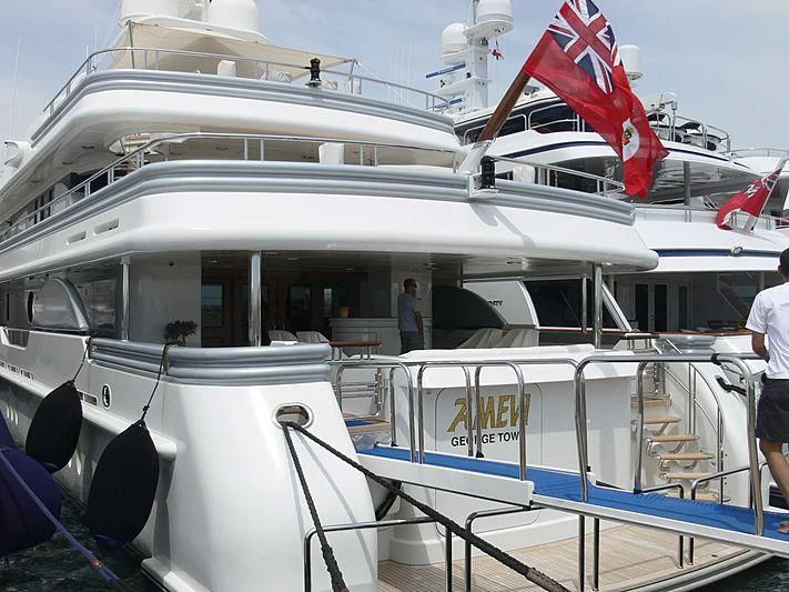a boat with a flag on the deck aboard DEJA TOO Yacht for Sale