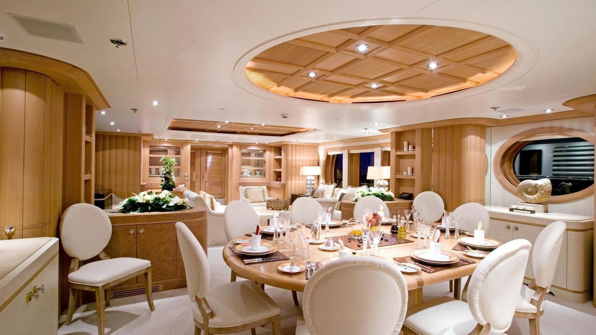 a large dining room with white chairs aboard DEJA TOO Yacht for Sale
