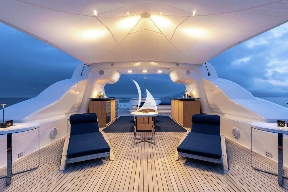 a room with a large bed and a table aboard DEJA TOO Yacht for Sale